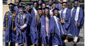 The first cohort of the GSEHD Educational Leadership and Administration program posed for photos their graduation attire in front of Gelman Library.